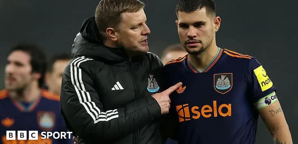 Coach discussing strategy with player on field