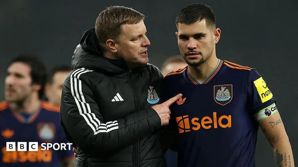 Coach discussing strategy with player on field