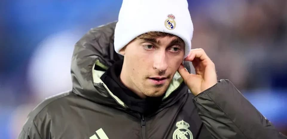 Player wearing Real Madrid jacket and beanie