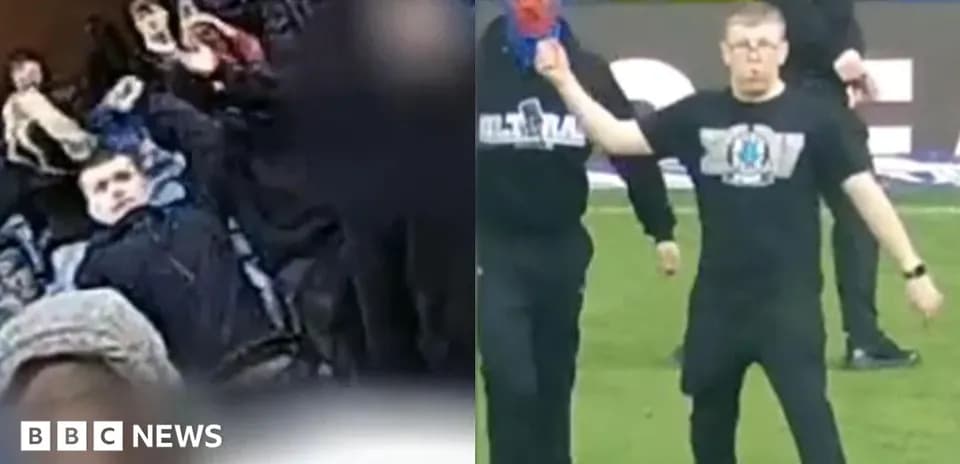 Fans in stands and a person on the pitch