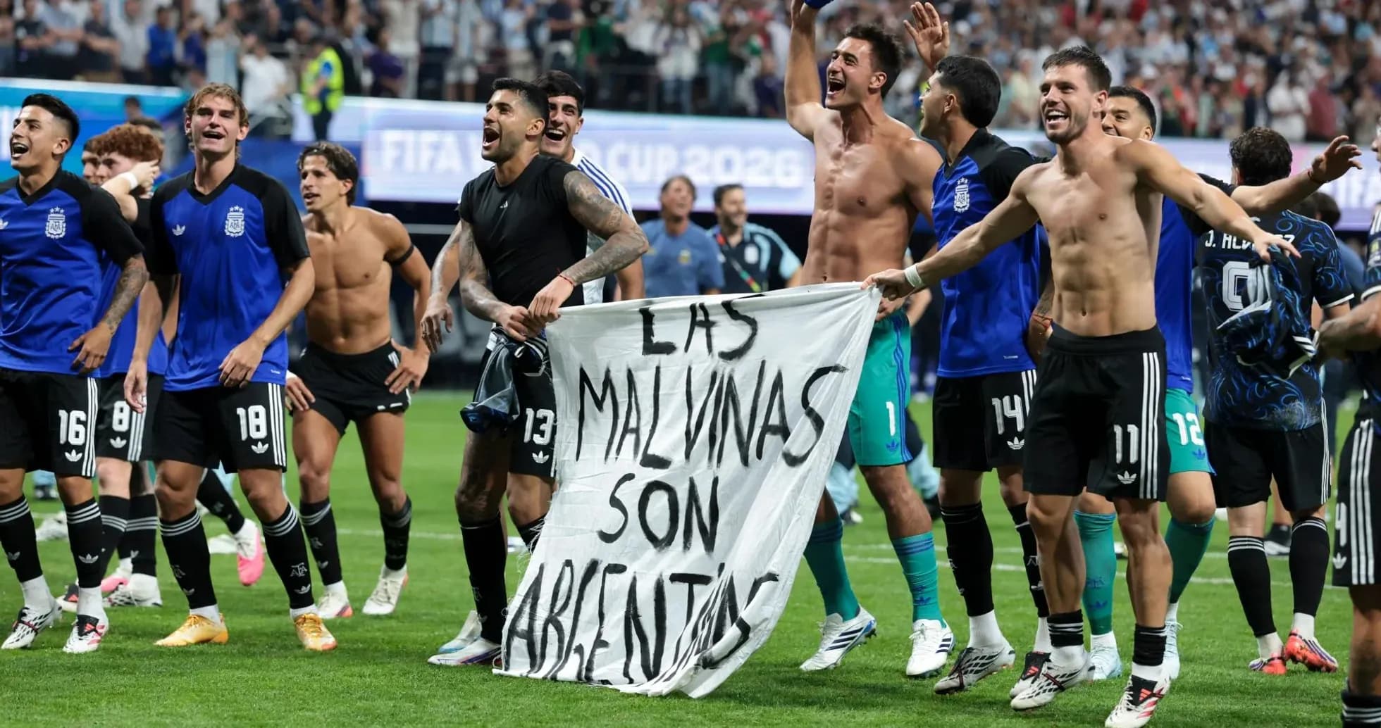 Argentina players celebrating with a banner on field