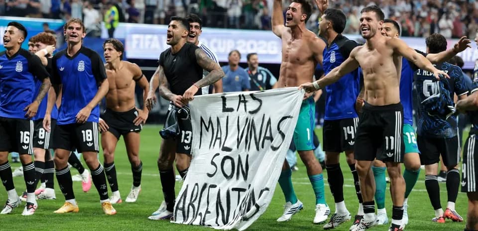 Argentina players celebrating with a banner on field