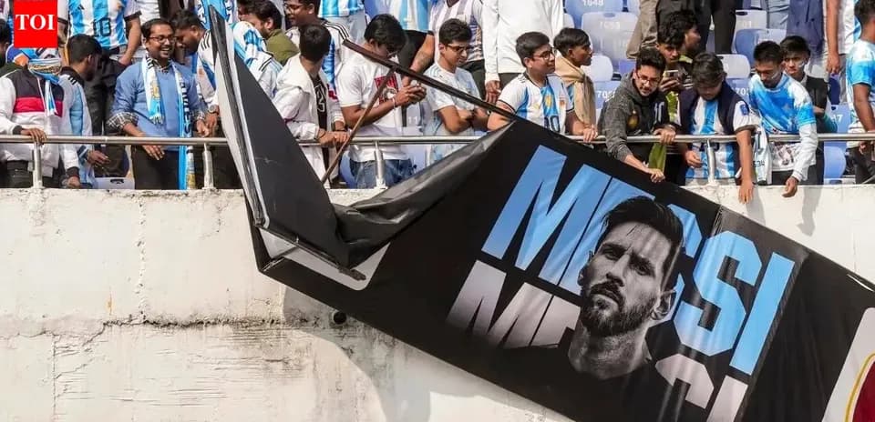 Fans in Argentina jerseys with Messi banner at stadium