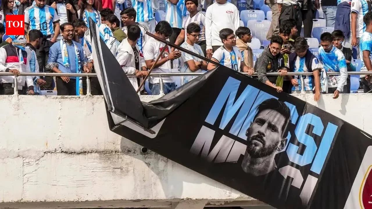 Fans in Argentina jerseys with Messi banner at stadium