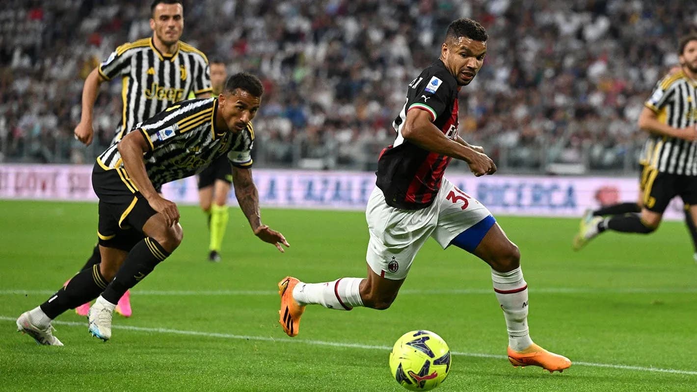 AC Milan player sprinting past Juventus defenders