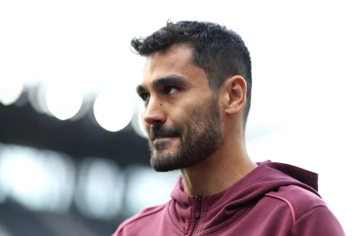 Player in maroon hoodie during pre-match preparation