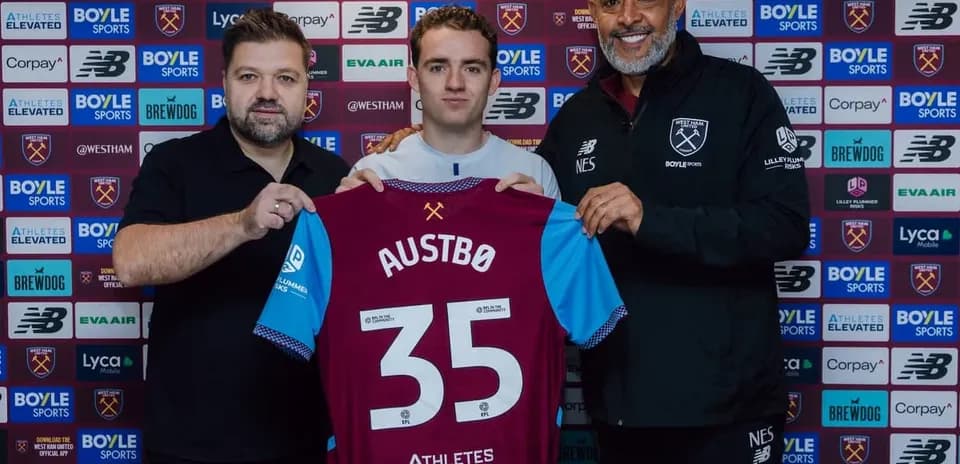 Player holding jersey at West Ham United announcement