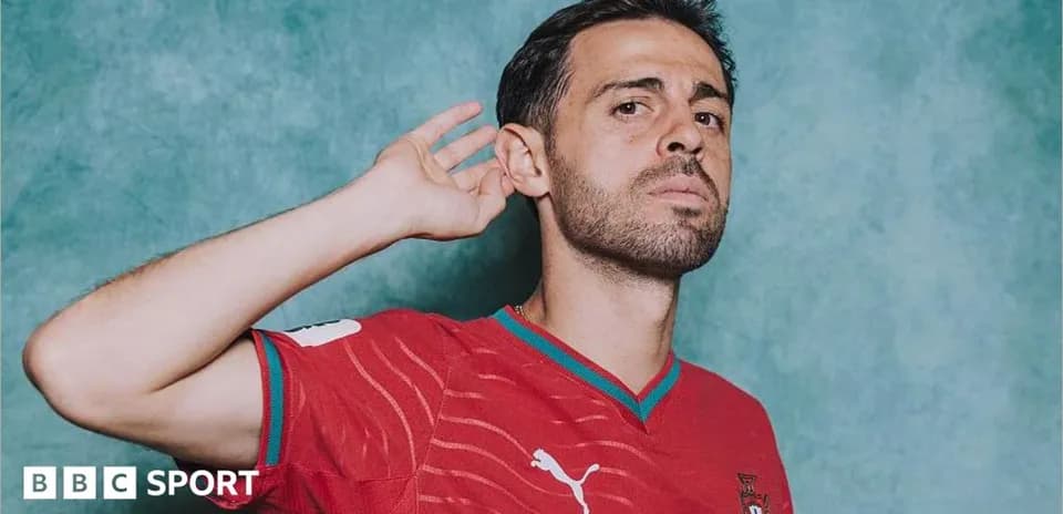 Football player posing in red Portugal jersey