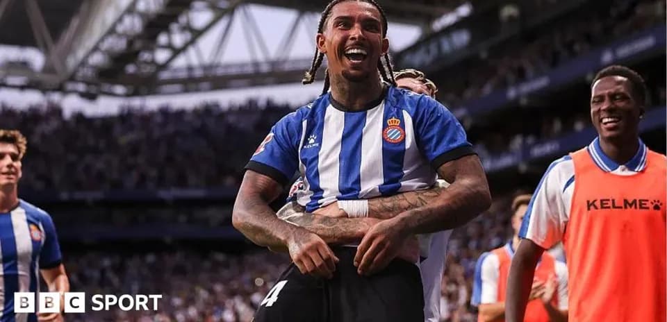 Player celebrating with teammates after scoring a goal