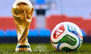 FIFA World Cup trophy next to a soccer ball