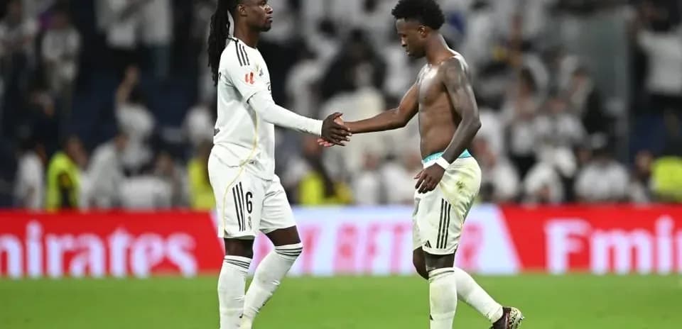 Two players shaking hands on the pitch