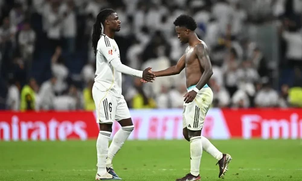Two players shaking hands on the pitch
