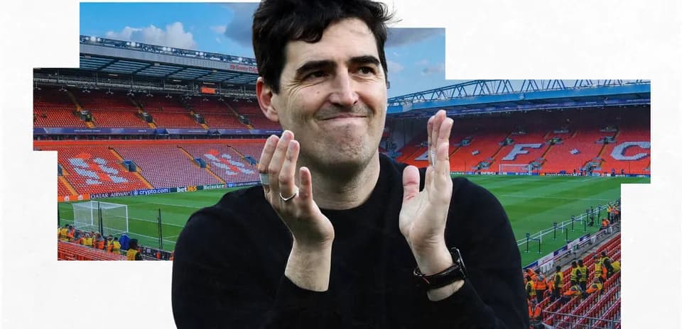 Person applauding in empty stadium with Liverpool branding