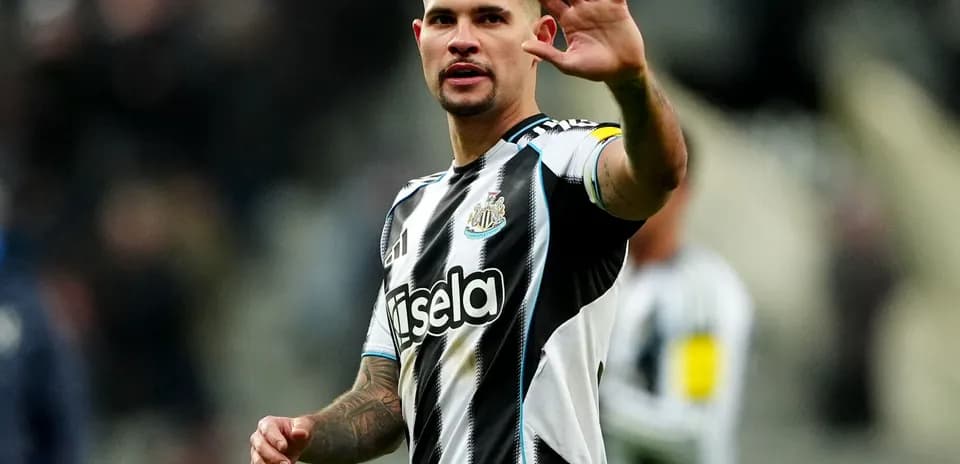 Player waving to fans during match at St James' Park