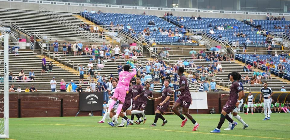 Goalkeeper catching the ball during match action
