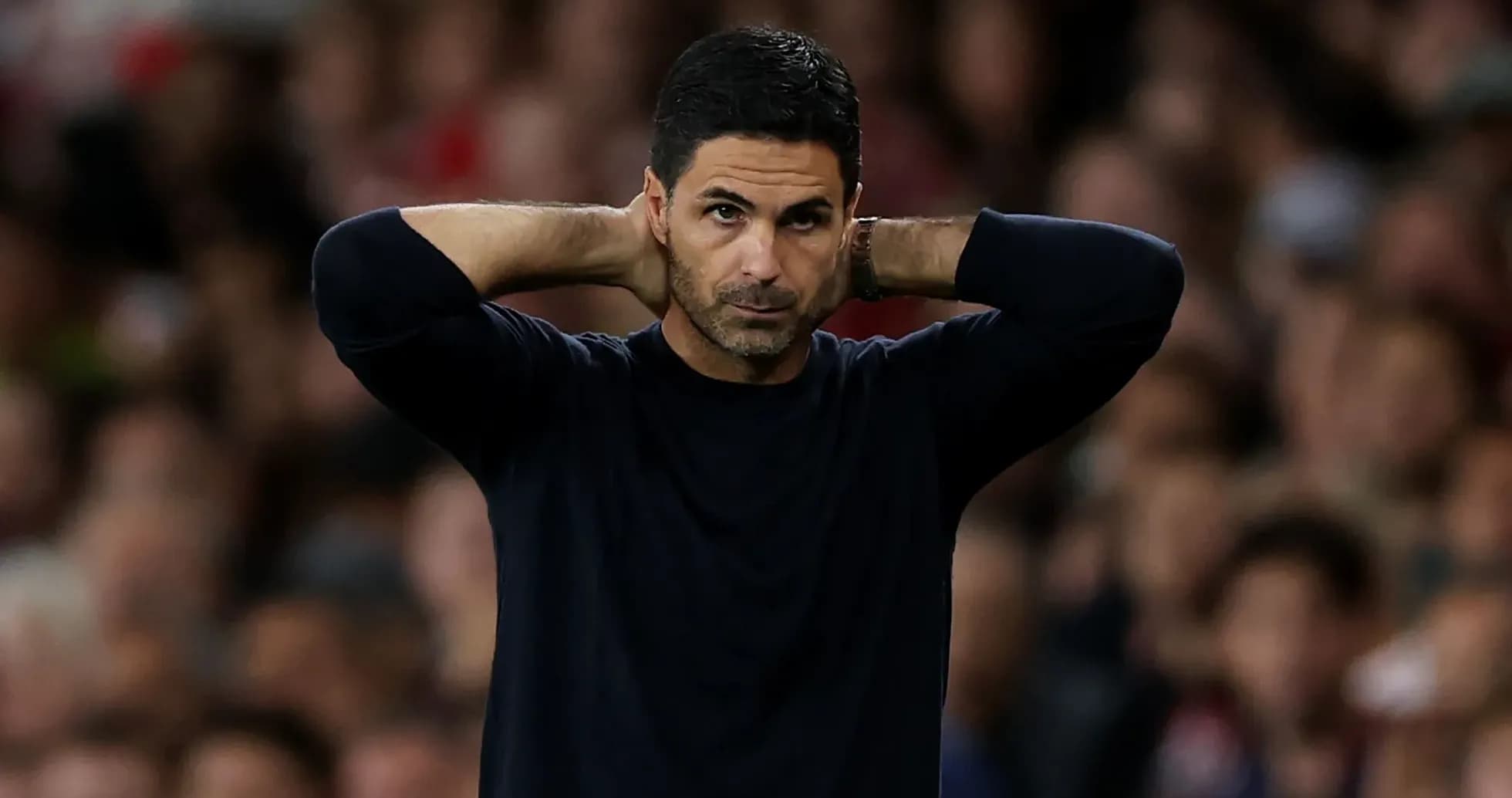 Manager with hands behind head during match