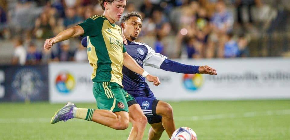 Player kicking ball during Huntsville City match