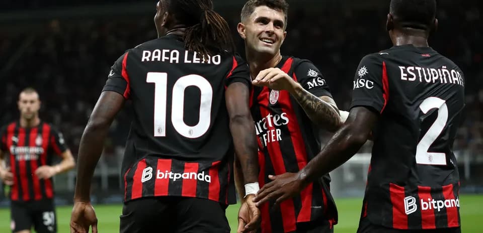 Players celebrating a goal on the field