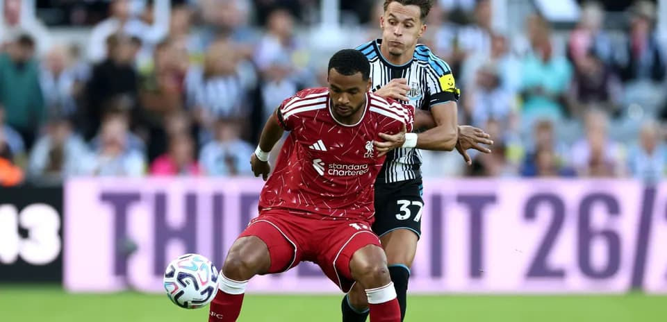 Liverpool player challenged by Newcastle opponent during match