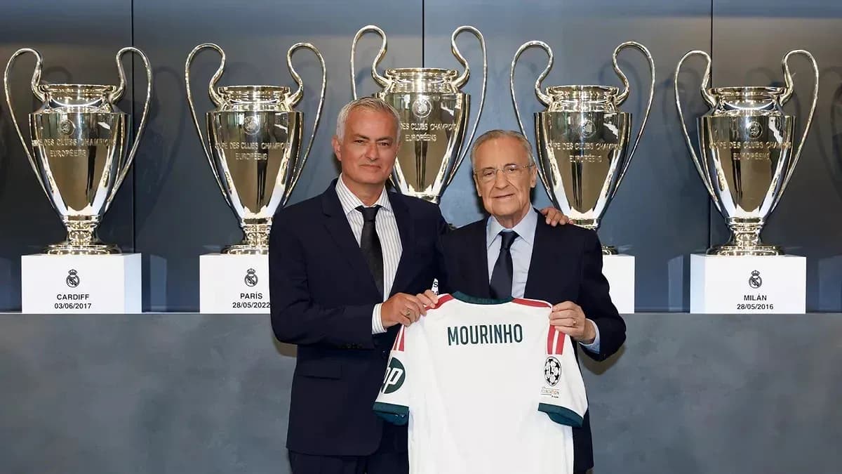 Jose Mourinho holding jersey with club president and trophies