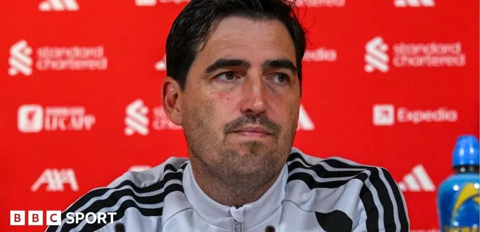 Manager at press conference with branded backdrop