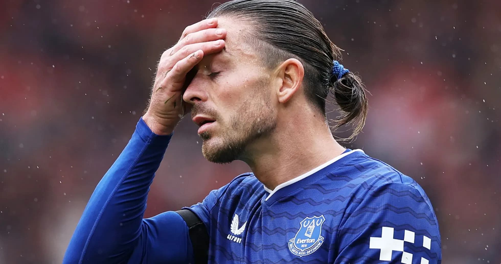Player in blue jersey holding head in disappointment