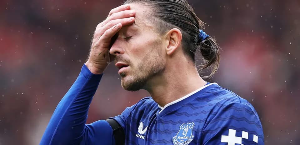 Player in blue jersey holding head in disappointment