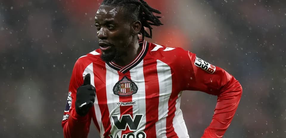 Sunderland player running in rain during match