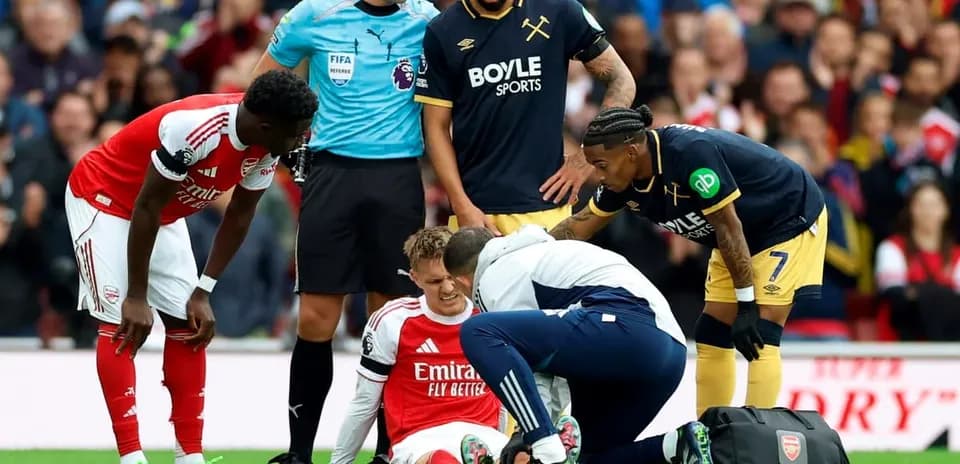Arsenal player receiving medical attention during match