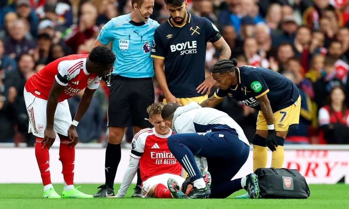Arsenal player receiving medical attention during match