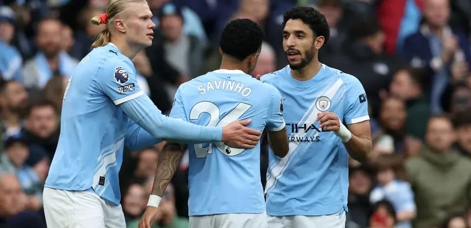 Manchester City players celebrating together on the field