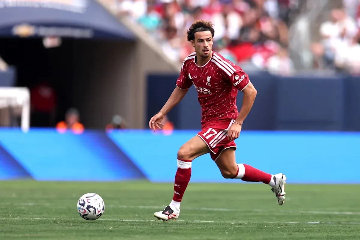 Liverpool player dribbling ball on field