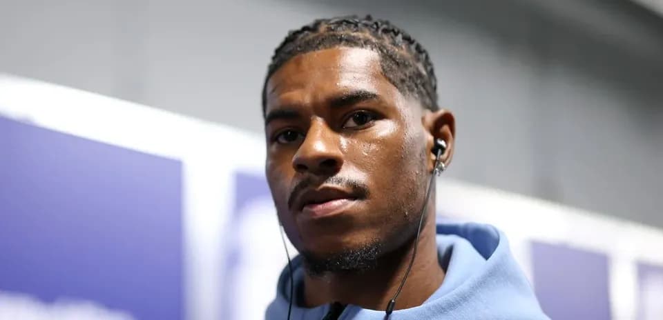 Player wearing headphones in a hallway