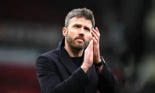 Coach clapping hands in stadium after match