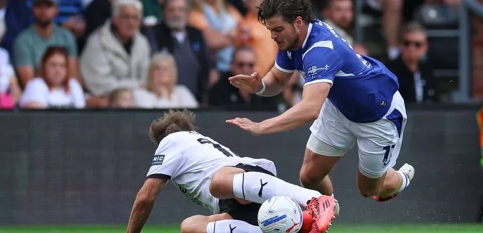 Player tackling opponent on the ground during match