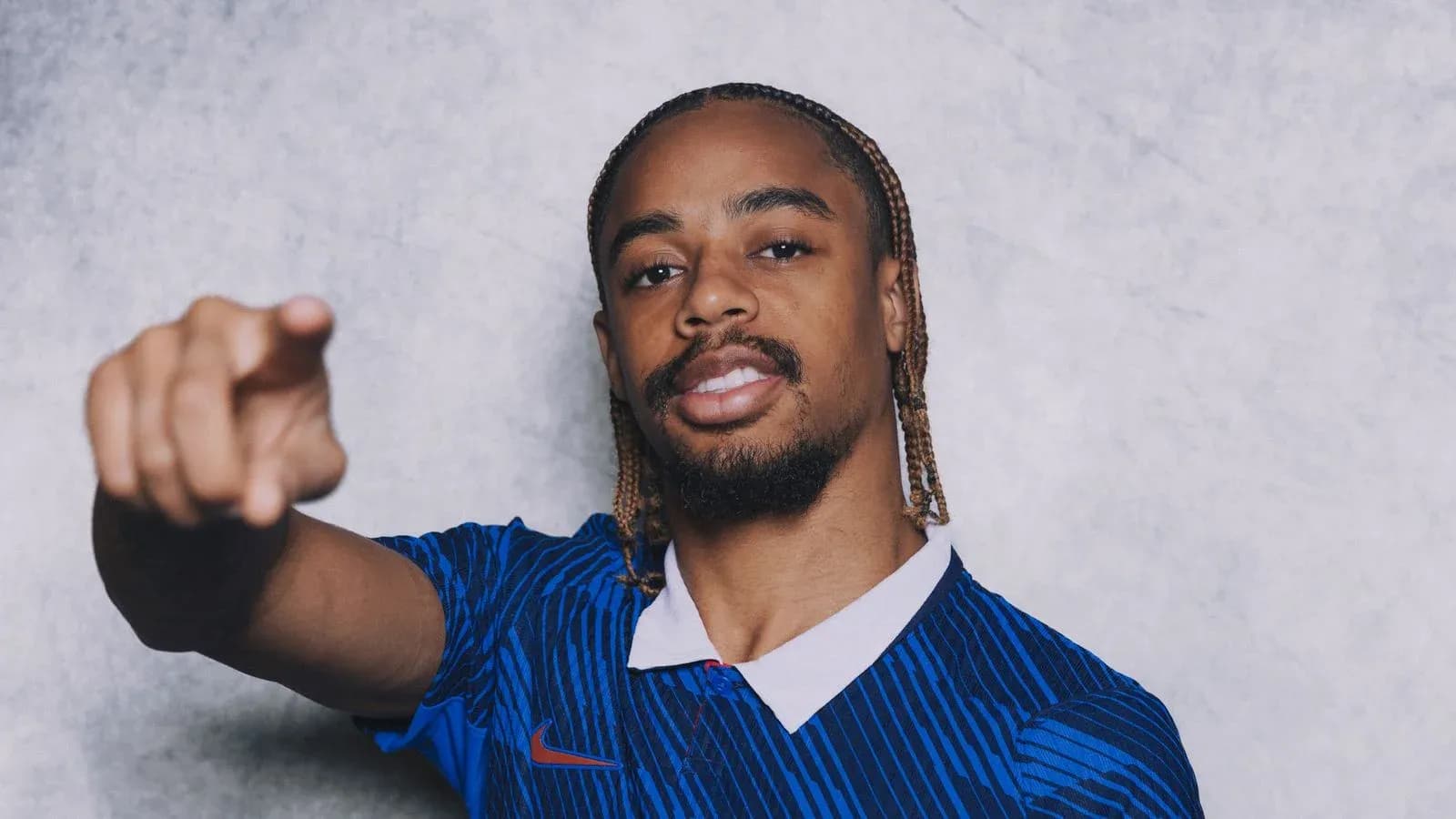 Player pointing while wearing blue sports jersey