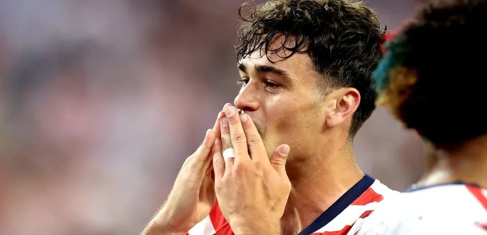 Player celebrating with hands to mouth during match