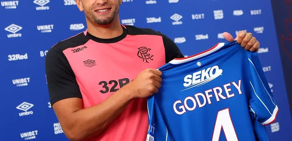 Player holding Rangers FC jersey with Godfrey name