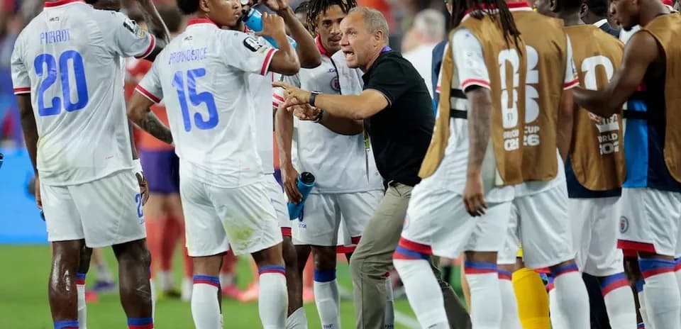 Haitian players receiving instructions during a match