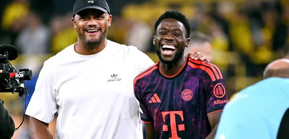 Two men laughing on the football field