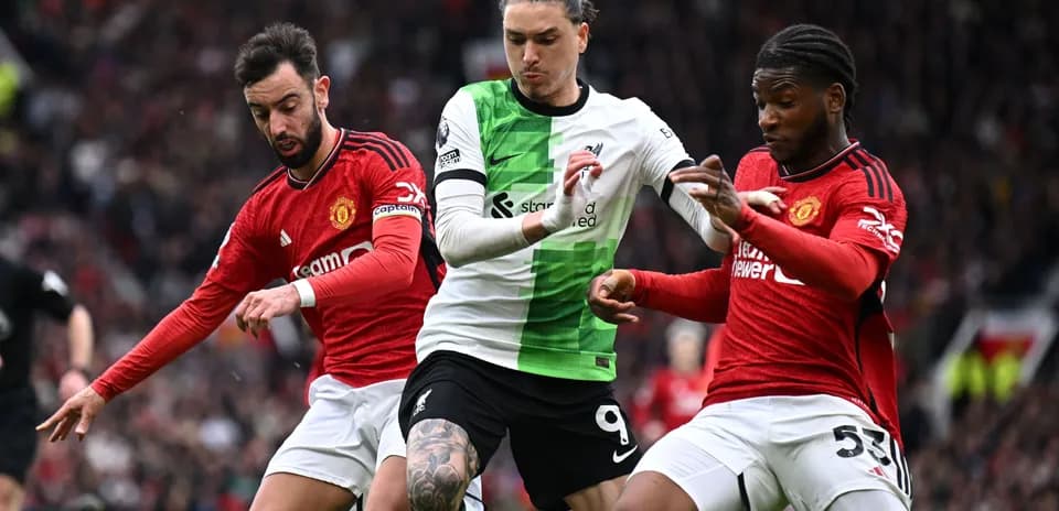 Three players contesting possession during match action