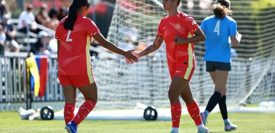 Two players greeting each other on field