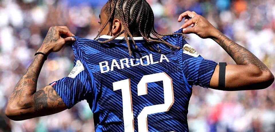 Player displaying jersey with name Barcola and number 12