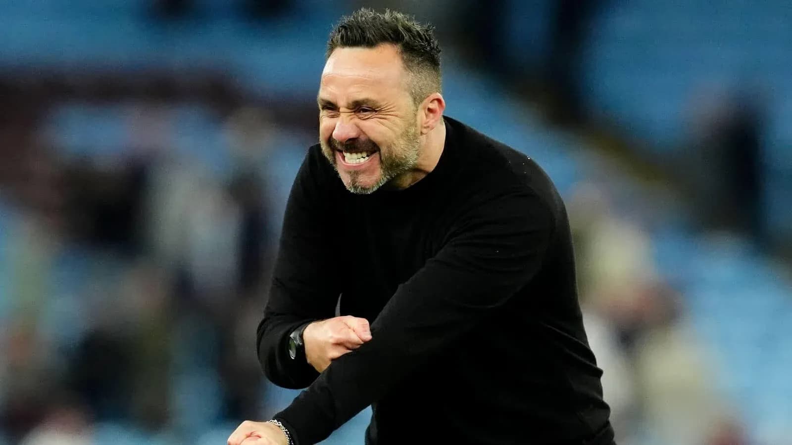 Coach celebrating enthusiastically on the sidelines