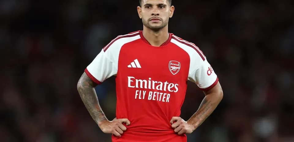Player in Arsenal kit standing with hands on hips