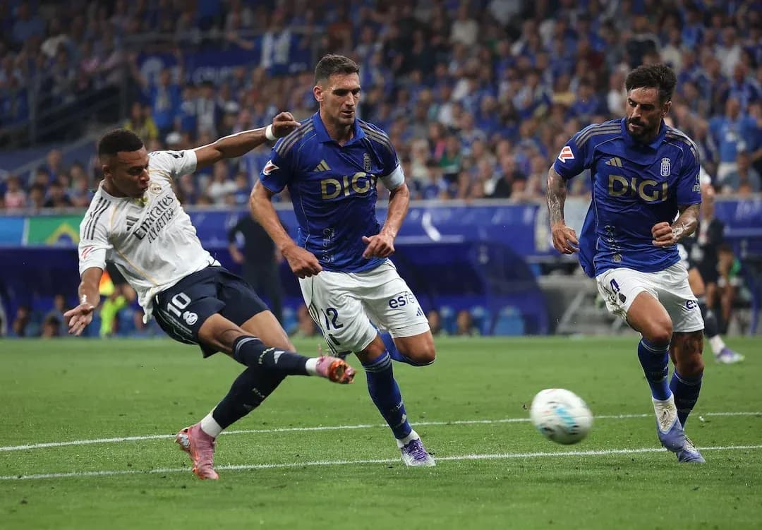 Real Madrid player attempting a shot on goal
