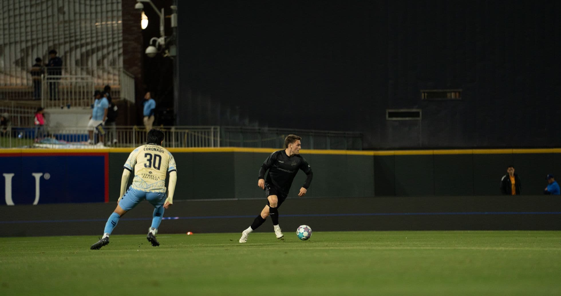 Player dribbling the ball during Colorado Springs match