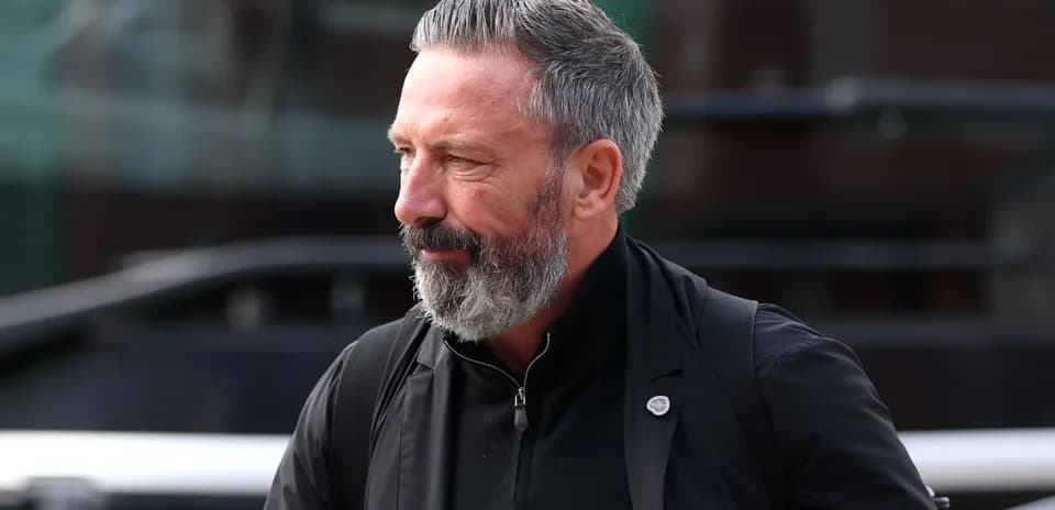 Man with gray beard walking in casual attire
