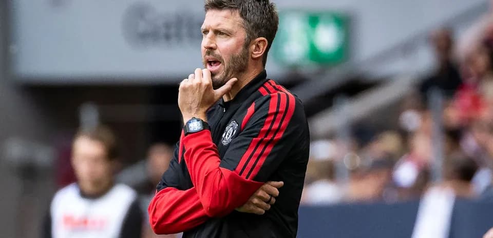 Coach gesturing thoughtfully during a match