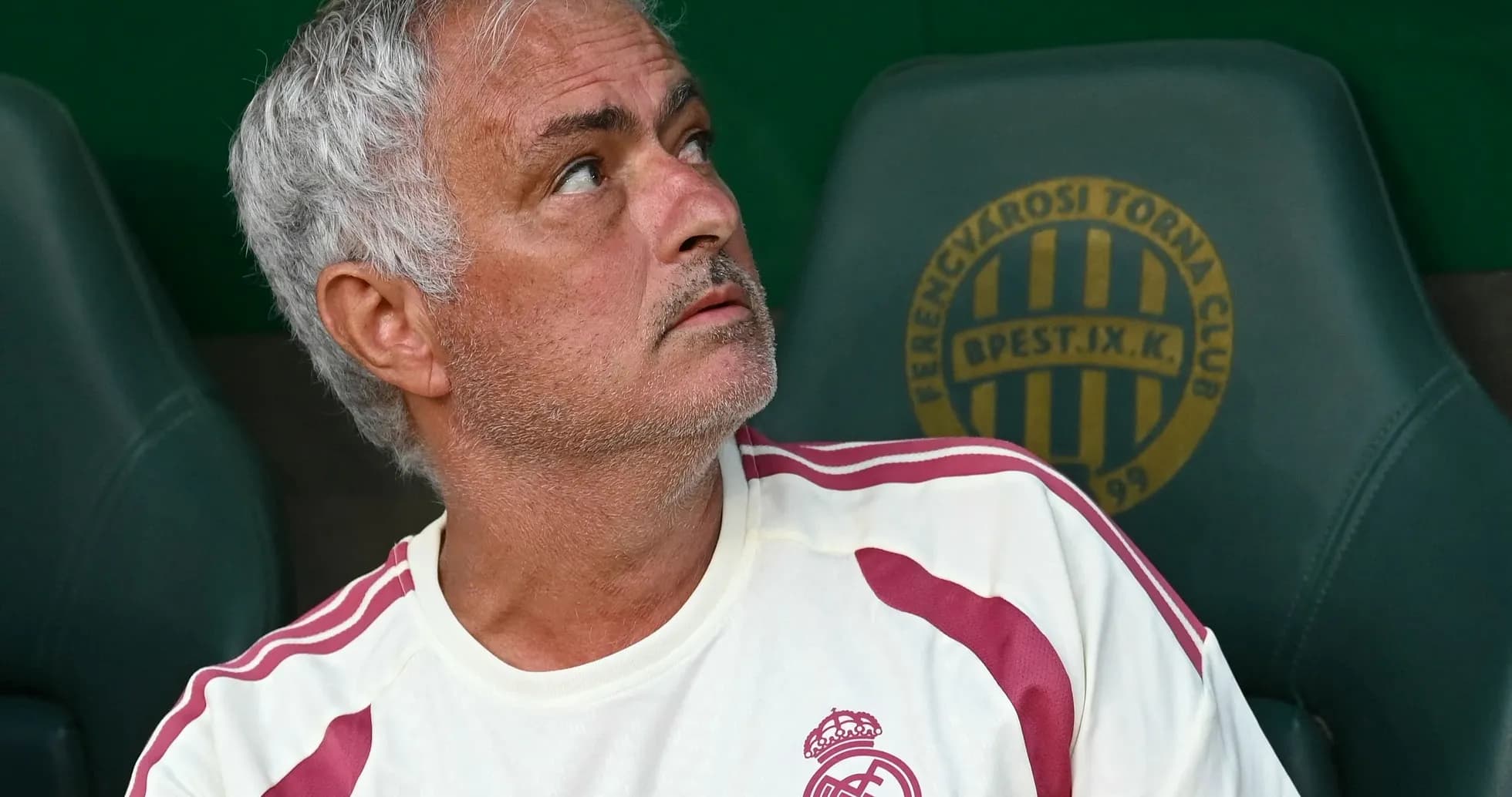 Coach seated on bench during match observation
